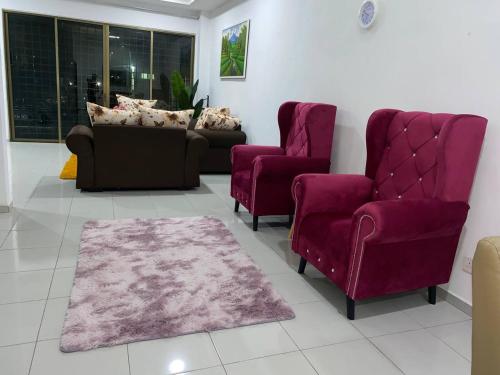 a living room with two chairs and a couch at Islamic Homestay Promenade Tanjung Lumpur in Kuantan