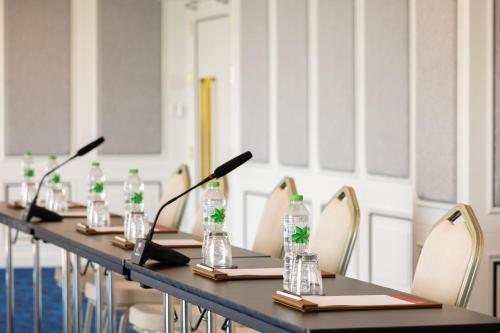 a long table with bottles of water and chairs at Eastin Hotel Vientiane in Vientiane