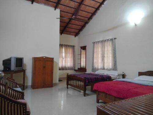 Säng eller sängar i ett rum på Prashanth Homestay