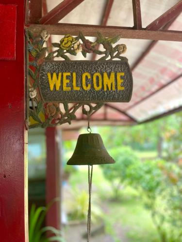 a welcome sign on a door with a bell at Casa San Pablo B & B in San Pablo