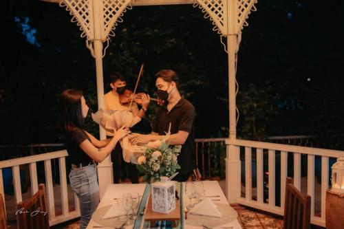 a group of people standing around a table on a gazebo at Casa San Pablo B & B in San Pablo