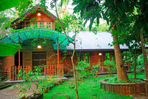 a house with a garden in front of it at Machcha Lodge Sigiriya in Sigiriya