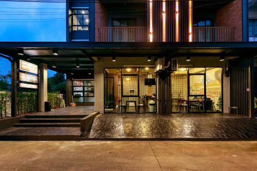 a house with a balcony and a patio at เดอะซิกเนเจอร์ นคร โฮเทล in Nakhon Si Thammarat