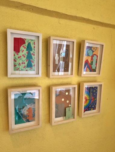 a group of pictures on a yellow wall at Casa San Pablo B & B in San Pablo