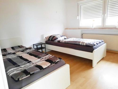 a bedroom with two beds and a window at Work & Stay in Kranenburg near Kleve in Kranenburg