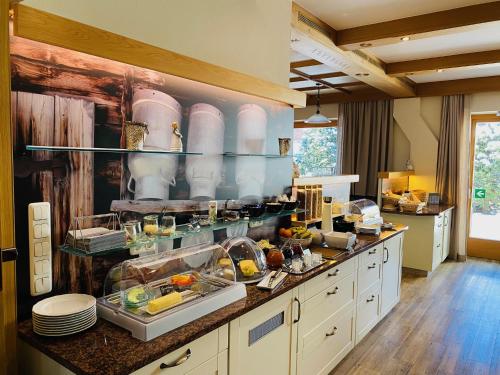 a kitchen with a counter with alot of dishes at Hotel Acherl in Achenkirch