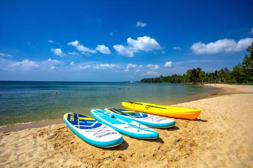a row of surfboards lined up on the beach at Ocean Bay Phu Quoc Resort and Spa in Phu Quoc