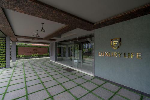 a lobby with a luxury life sign on the wall at BBC Luxury Apartments in Perintalmanna