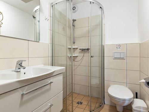a bathroom with a shower and a toilet and a sink at Two-Bedroom Holiday home in Wendtorf 3 in Wendtorf