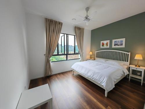 a bedroom with a bed and a large window at Cozy Suite with 270 Degree Mountain and Theme Park Views in Ipoh