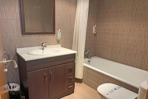 a bathroom with a sink and a toilet and a tub at Apartamentos Canillo 3000 in Canillo