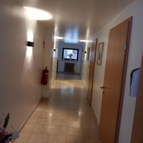 a hallway with a long hallway with a light on at Pension Alpina in Roppen