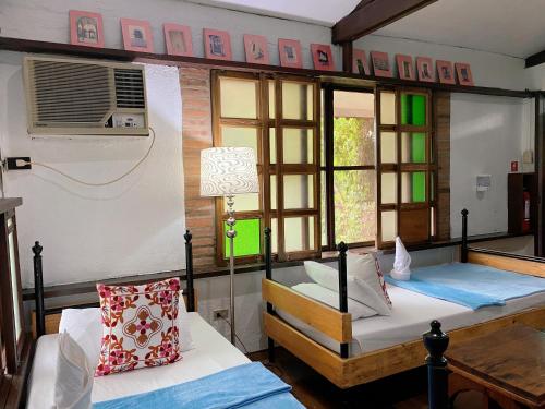 a bedroom with two beds and a window at Casa San Pablo B & B in San Pablo
