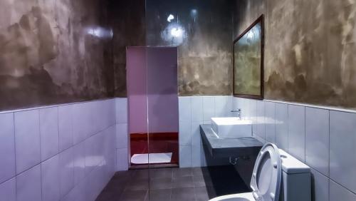 a bathroom with a sink and a toilet at The Riva Vientiane Hotel in Vientiane