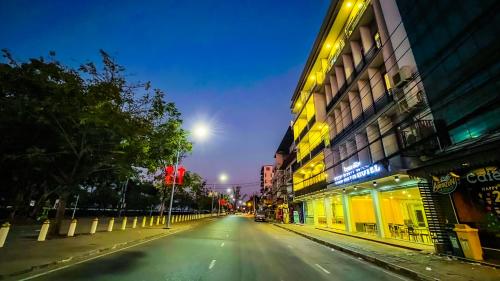 an empty street in a city at night at The Riva Vientiane Hotel in Vientiane