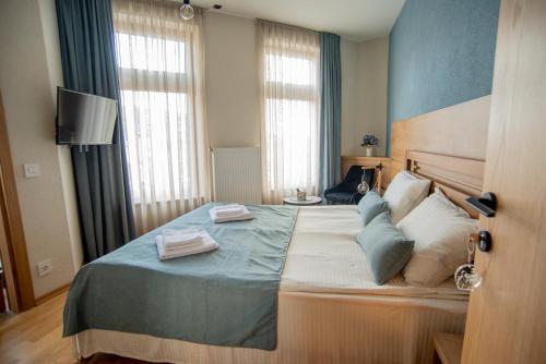 a bedroom with a bed with two towels on it at Boutique Hotel St Nikolas by Skar in Kruševo