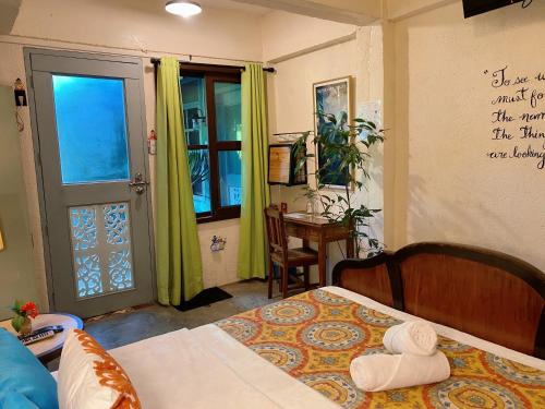 a bedroom with a bed and a door with a window at Casa San Pablo B & B in San Pablo