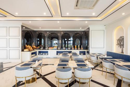 a dining room with tables and chairs and a bar at Eastin Hotel Vientiane in Vientiane