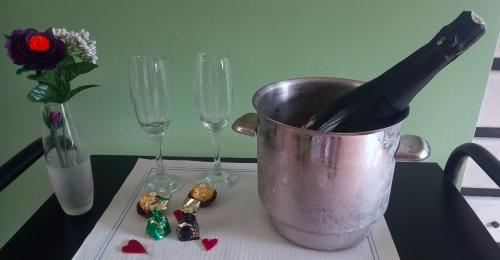 a bottle of wine in a bucket on a table with wine glasses at Motel Montecarlo in Teo