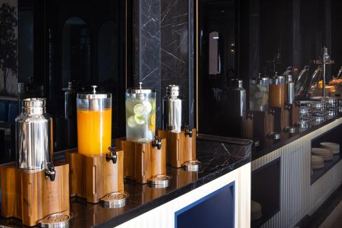 a bar with bottles of orange juice on a counter at Eastin Hotel Vientiane in Vientiane