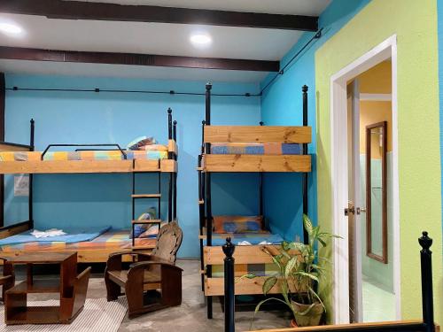 a room with bunk beds and a table and chairs at Casa San Pablo B & B in San Pablo