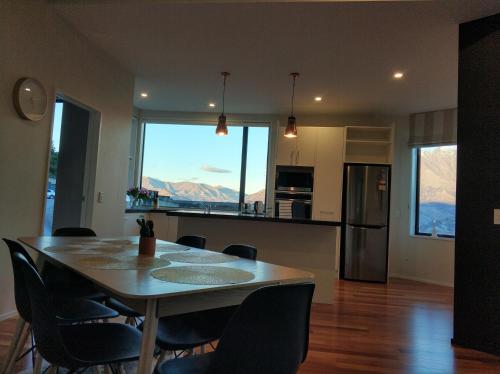 a dining room and kitchen with a table and chairs at GoldRush Haven in Queenstown