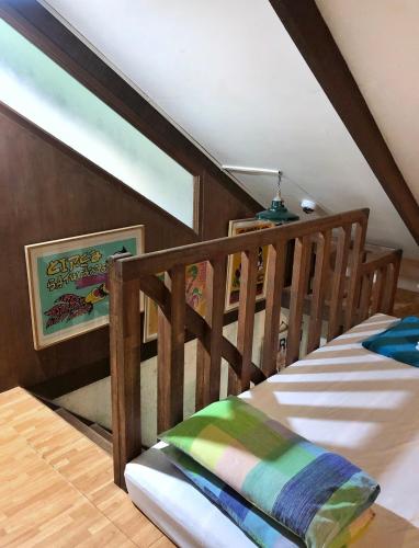 a bedroom with a wooden crib in a attic at Casa San Pablo B & B in San Pablo