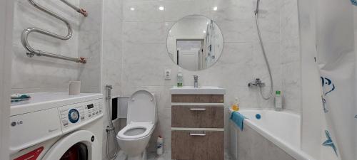 a bathroom with a toilet and a sink at Аэропорт 10 минут жк Будапешт163 in Astana