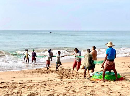 a group of people playing on the beach at Seth Villa by Magampura Resorts in Tangalle