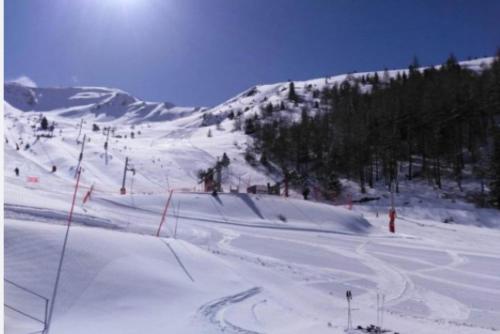 a snow covered ski slope with a ski lift at Private riverside villa with breathtaking views in Axat