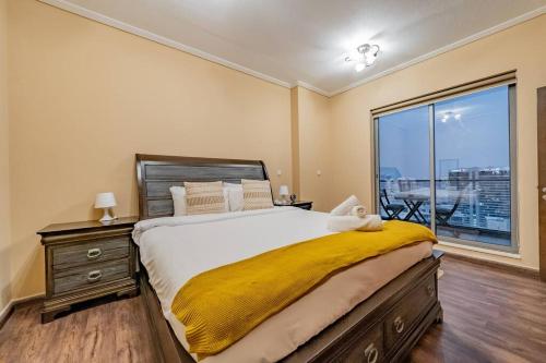 a bedroom with a large bed and a large window at Stunning 1 bedroom w pool in Downtown in Dubai