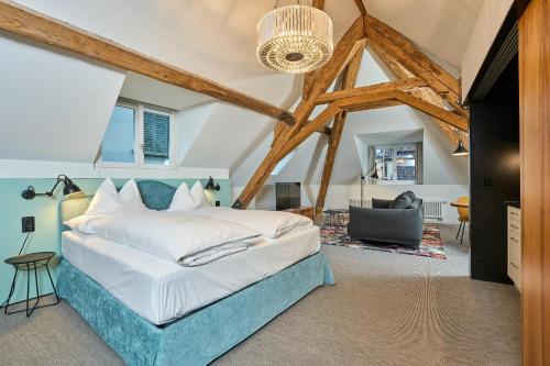 a bedroom with a bed with a blue headboard at Limmathof Baden - Historisches Haus & Spa in Baden