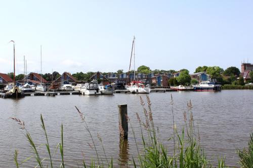 a marina with boats in the water and houses at Ferienwohnung Landgang 25494 in Weener