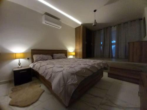 a bedroom with a large bed and a window at Brand new 1 bedroom studio flat in Gudja