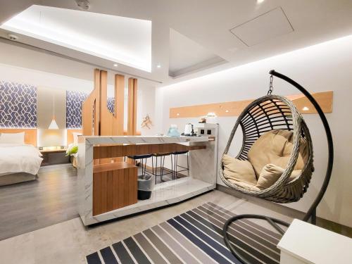 a room with a hanging chair and a bed at CHECK inn Taichung Zhongshan in Taichung