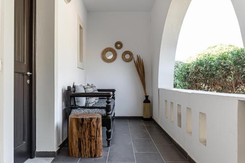 a hallway with a table and a window at Zefyros Studios in Plaka