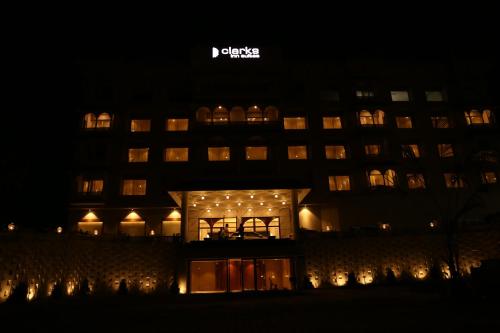 a large building with lights in front of it at night at Clarks Inn Suites Raipur in Raipur