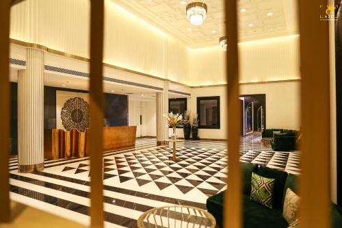 a lobby with a black and white checkered floor at Clarks Inn Suites Raipur in Raipur