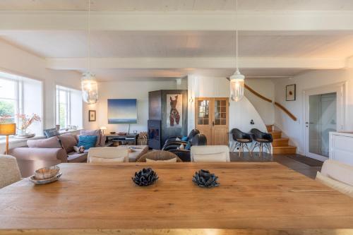 a living room with a large wooden table in a room at Andrea in Aventoft