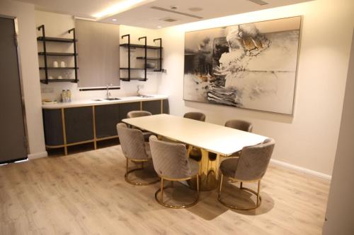 a dining room with a table and chairs at Vittori Palace Hotel and Residences in Riyadh