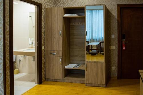 a bathroom with a shower and a sink and a mirror at Inga Hotel Yerevan in Yerevan