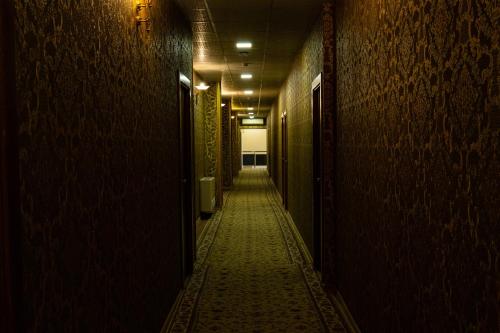 a dark hallway with a long corridor at Inga Hotel Yerevan in Yerevan