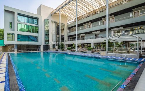 an indoor swimming pool in a building with a building at The Fern Residency Mumbai in Mumbai