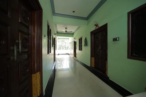 a hallway of a room with a door and a floor at Karthik residence in Puducherry