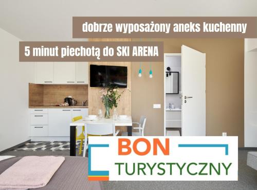 a kitchen and a dining room with a table in a room at Villa Alpina - 5 minut do szlaków i wyciągów in Szklarska Poręba