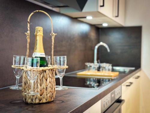 a bottle of champagne in a basket on a kitchen counter at Appartement Heim in Sankt Gallenkirch