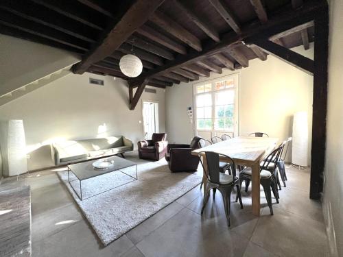 un salon avec une table et un canapé dans l'établissement Maison en pleine forêt à 10min de Reims, à Saint-Brice-Courcelles