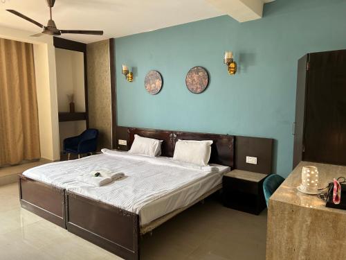 a bedroom with a bed and two plates on the wall at The Aster Penthouse in Kolkata