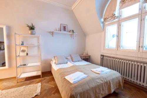 a bedroom with two beds and a window at 2ndhomes Cozy & Compact Top Floor Studio in Erottaja in Helsinki