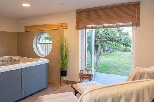 a bathroom with a tub and a sink and a mirror at Villa federleicht in Medebach